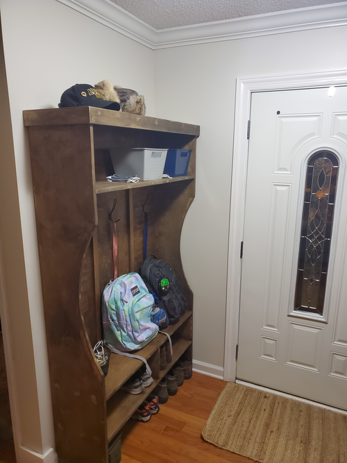 Completed locker in installed in front entry with backpacks, hats and shoes stored
