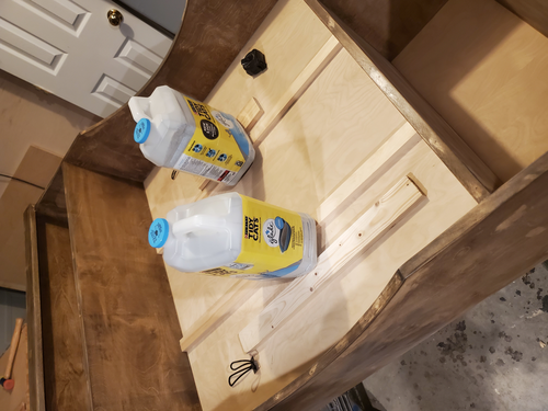 Kitty litter containers applying pressure to decorative vertical dividers during glue-up